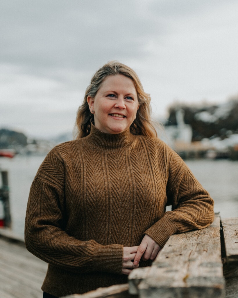 woman with brown knitted sweater smiling