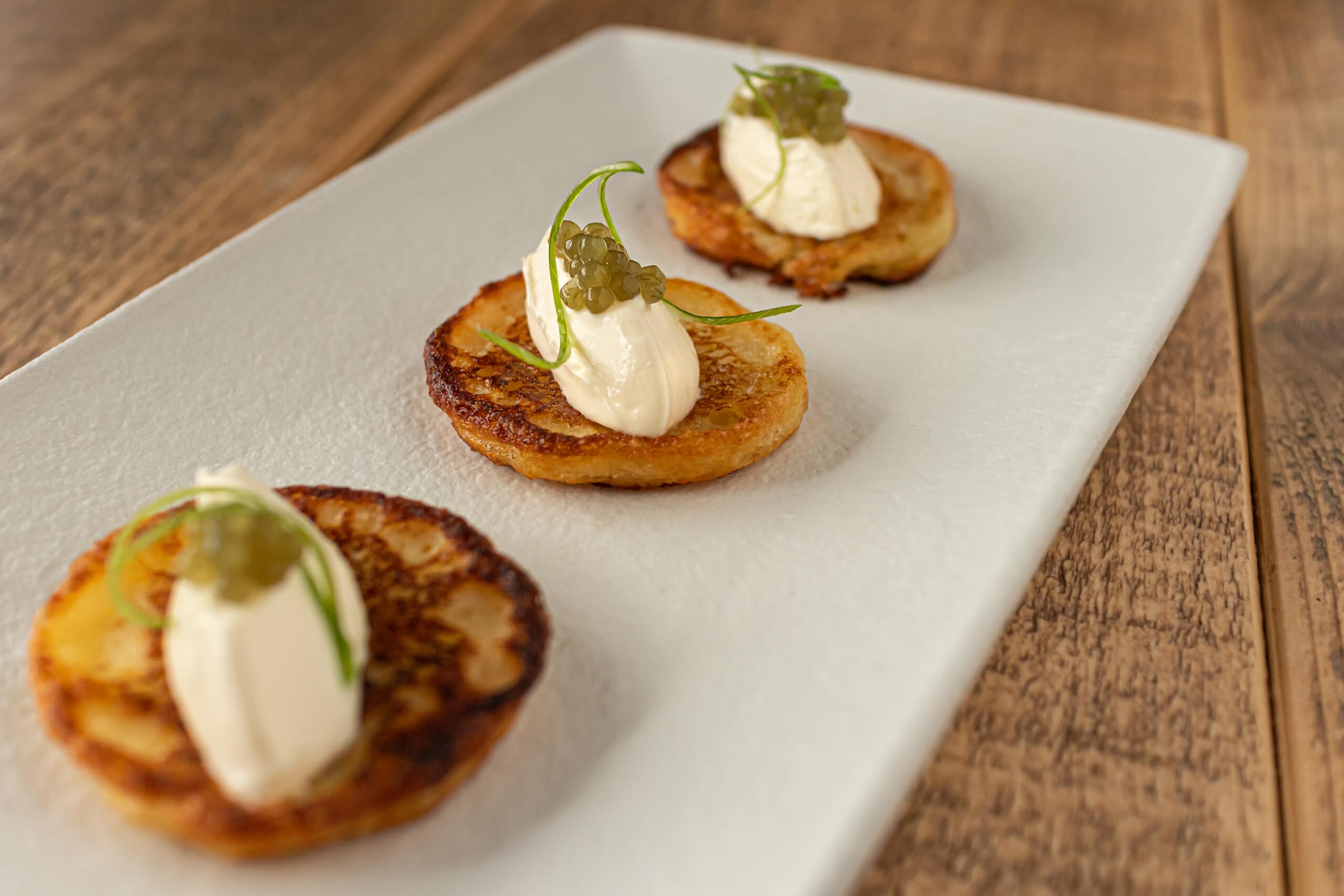 blinis on a plate with seaweed caviar arctic ocean pearls