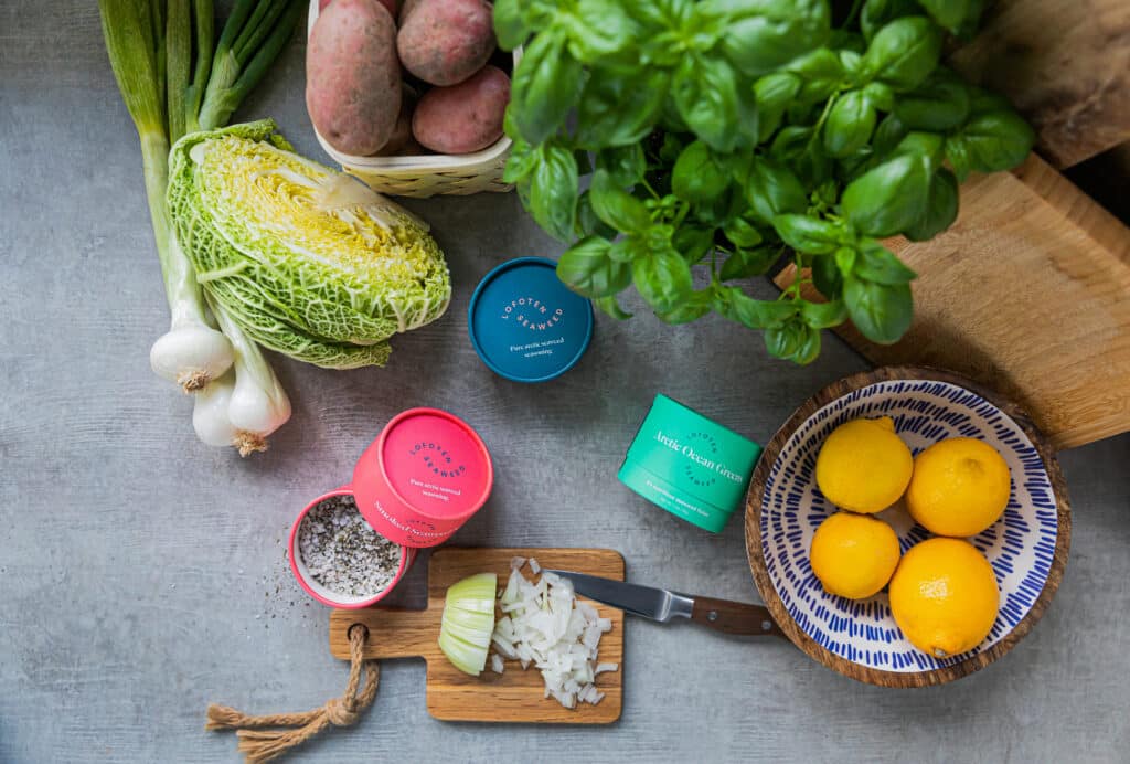 Seaweed Salts on a table with assorted vegetables and lemons